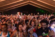 A lively night scene with a diverse crowd enjoying a music festival.